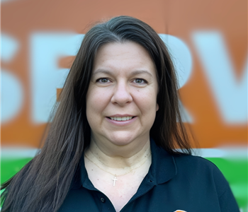 Woman with brown hair wearing a black shirt